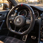 Golf 7 GTI : volant monté vu depuis le siège passager, bas plat et carbone brillant